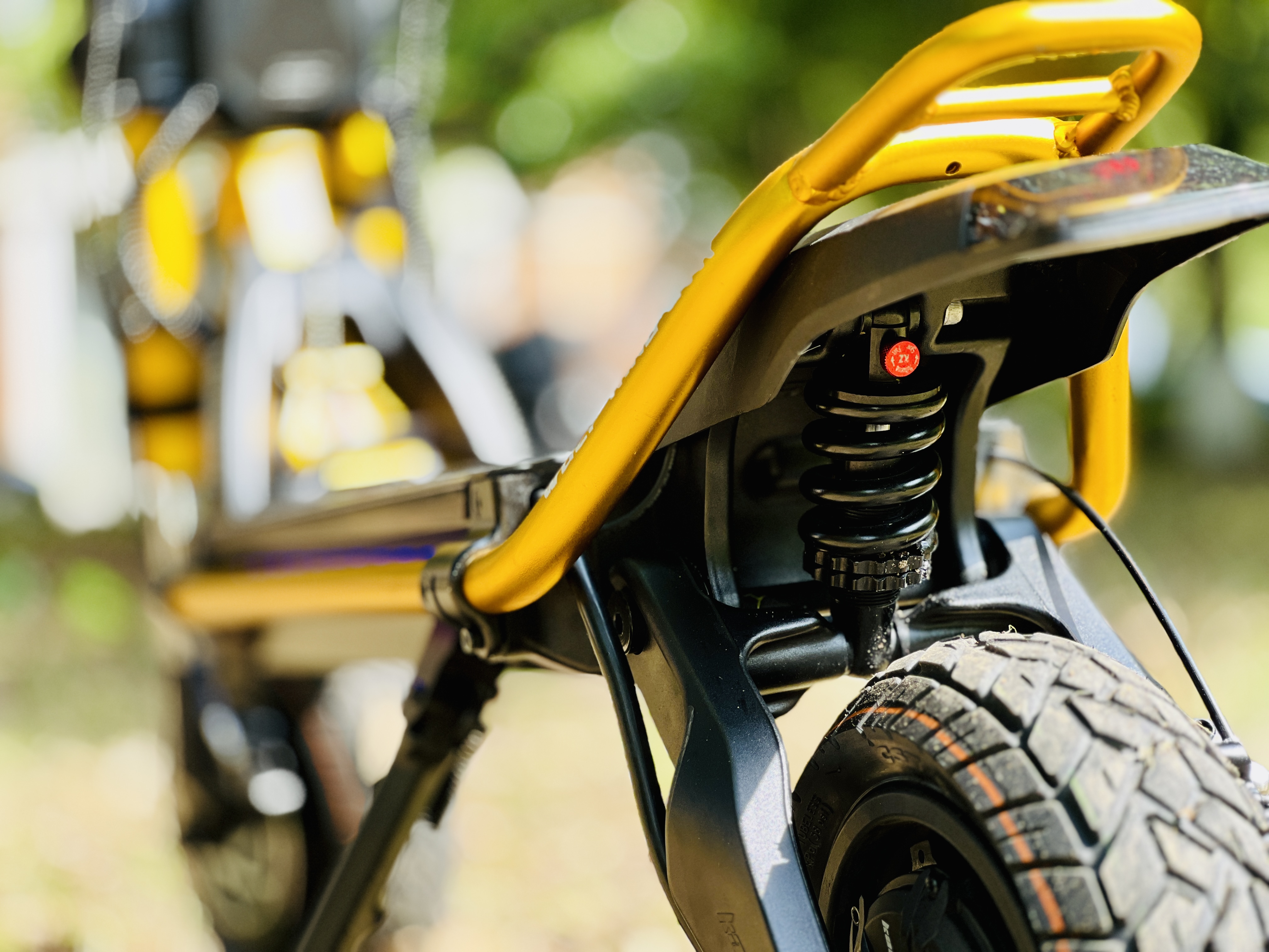 Close-up of yellow electric bike rear suspension