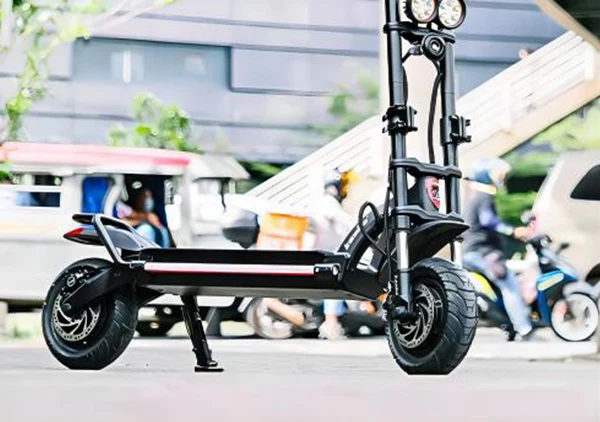 Black electric scooter parked on city street