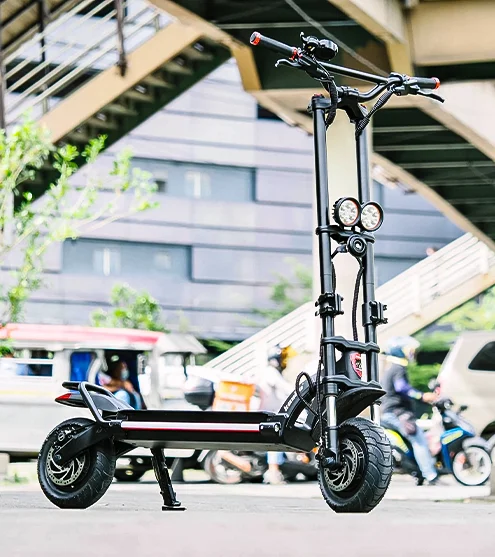Parked black electric scooter with dual headlights