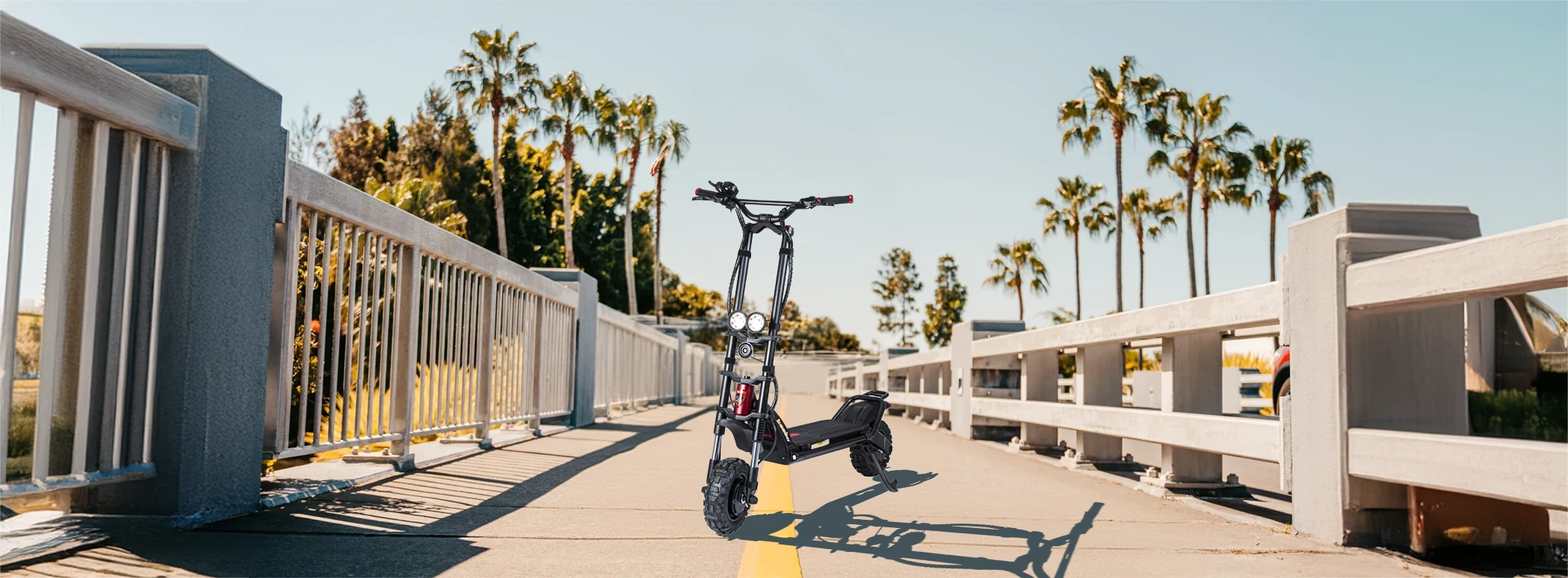 Electric scooter parked on sunny bridge with palms